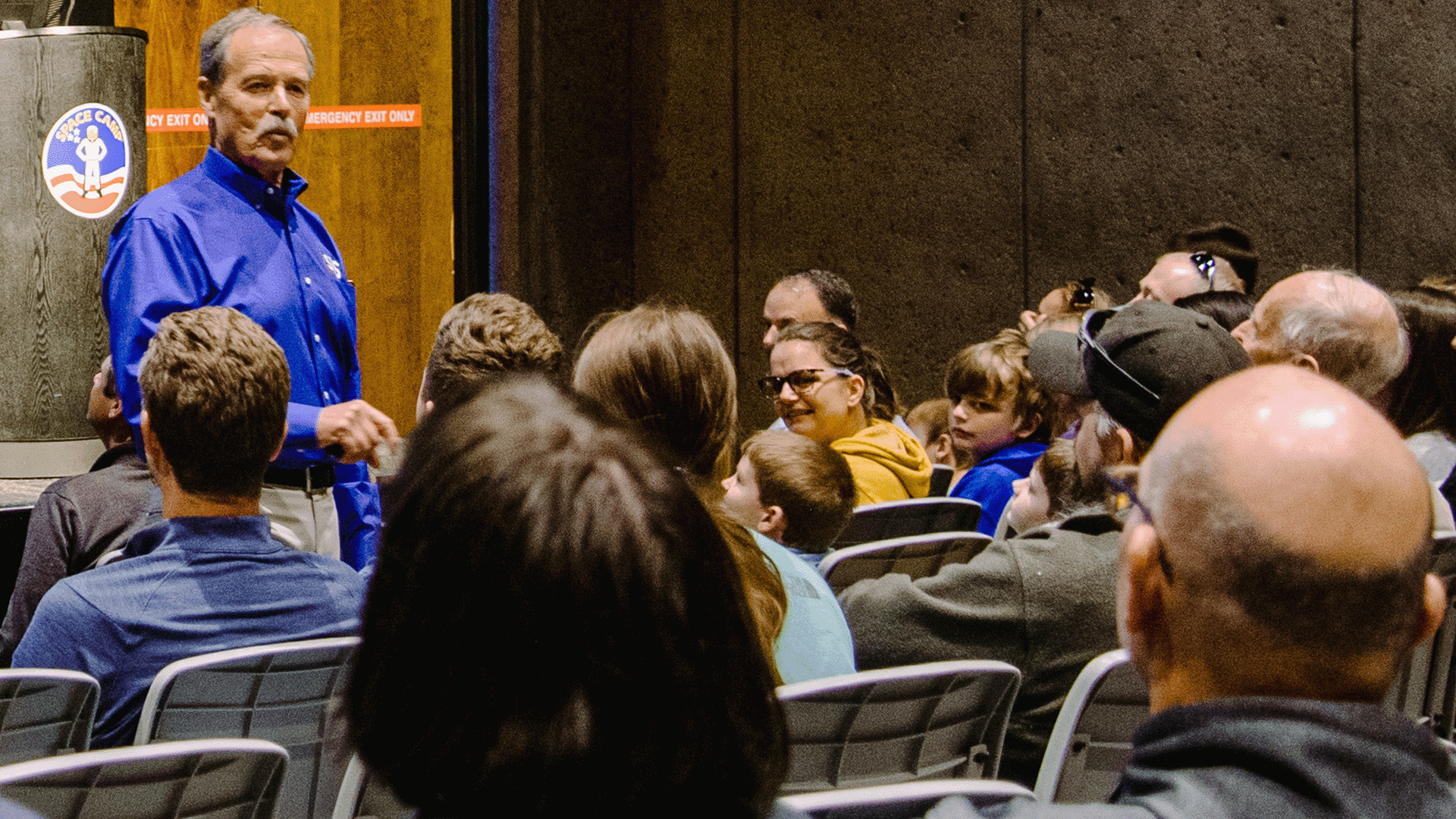 Astronaut Hoot Gibson speaks to an audience at the U.S. Space & Rocket Center