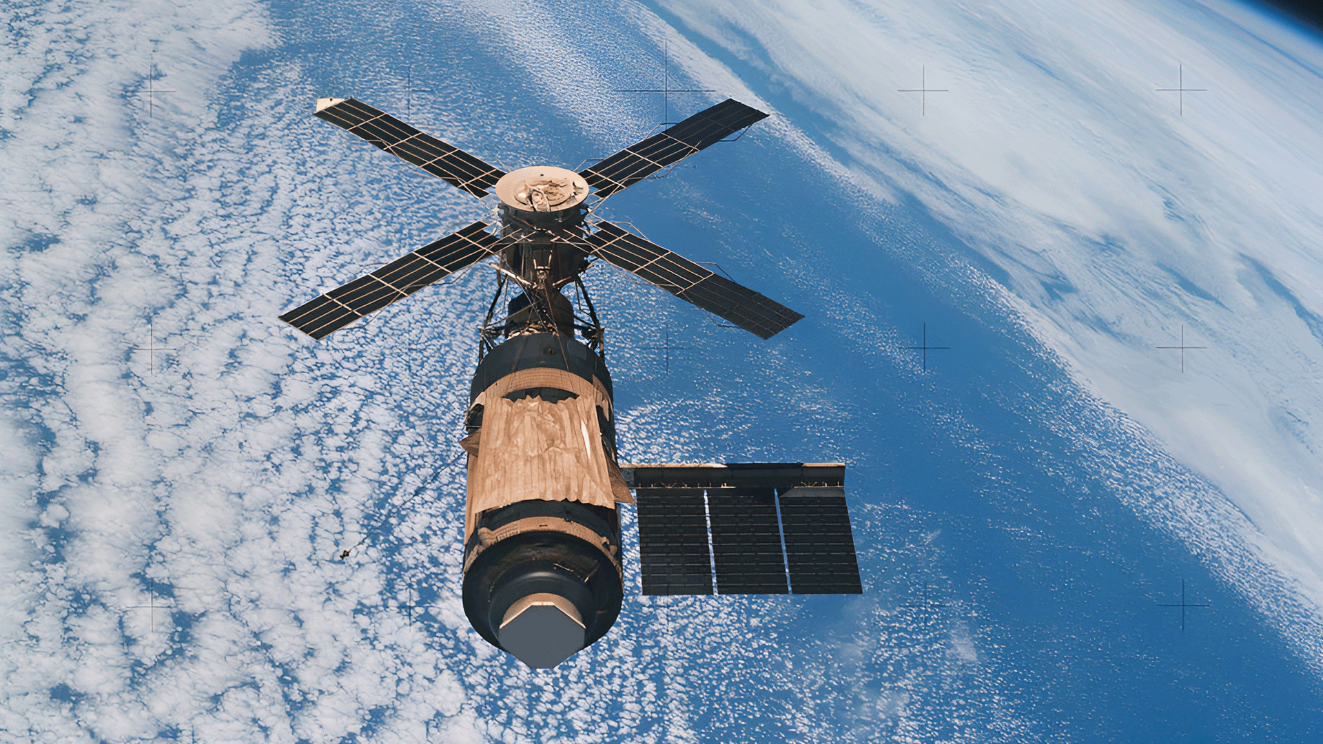 An overhead view of the Skylab space station cluster in Earth orbit as photographed from the Skylab 4 Command and Service Modules (CSM) during the final fly-around by the CSM before returning home. 