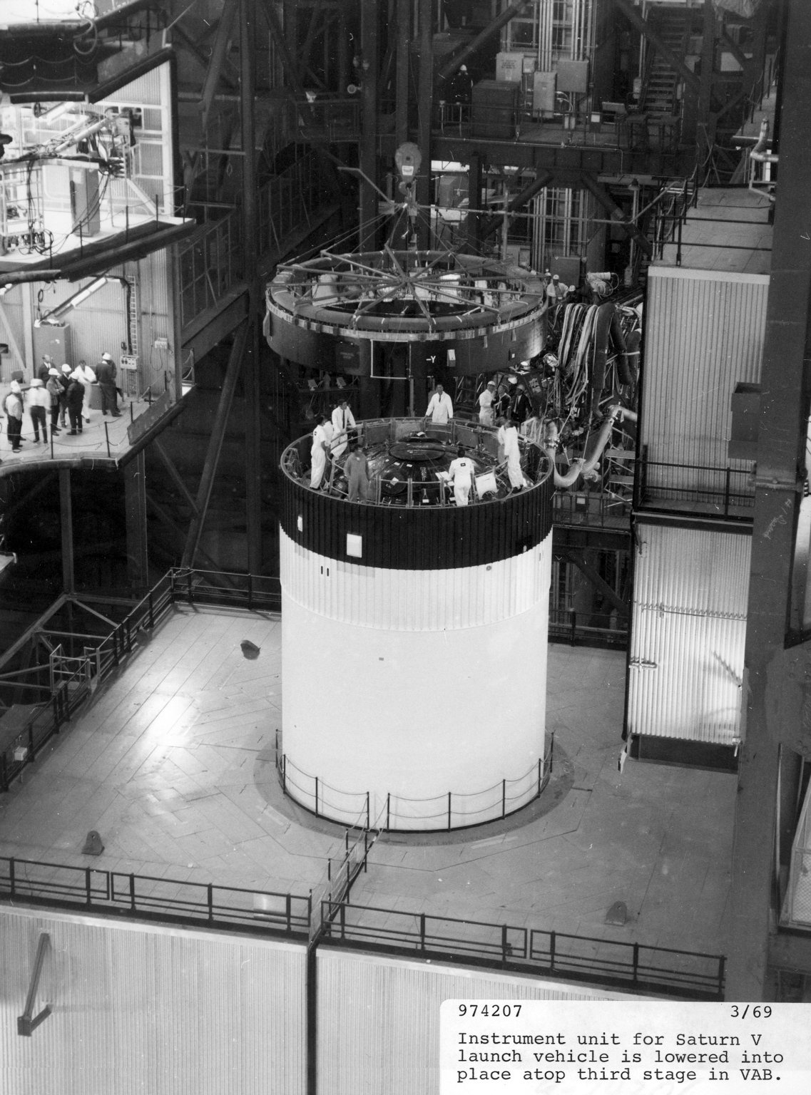 Instrument unit for Saturn V launch vehicle being lowered into place