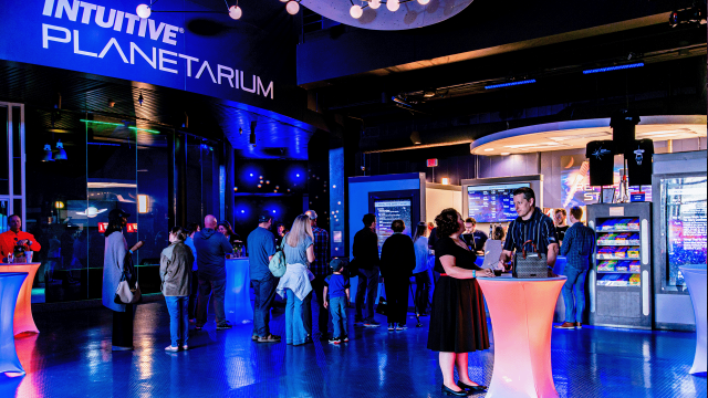 A couple enjoy drinks in the lobby of the INTUITIVE Planetarium