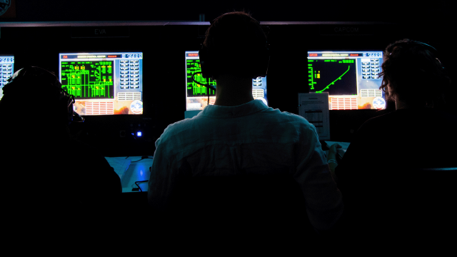 Trainees monitor as simulated space mission from their stations at Mission Control