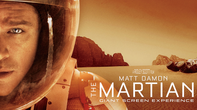 A close up of Matt Damon's face as Astronaut Mark Watney standing on the surface of Mars