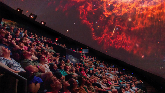 Individuals enjoying a show in the Planetarium