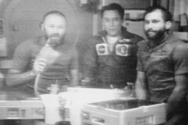 The three members of the Skylab 4 crew confer via television communication with Dr. Lubos Kohoutek, discoverer of the Comet Kohoutek. This picture of the three astronauts was reproduced from a TV transmission made by a TV camera aboard the space station in Earth orbit. They are, left to right, Gerald P. Carr, commander; Edward G. Gibson, science pilot; and William R. Pogue, pilot. 