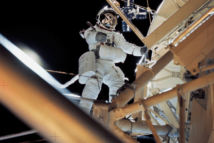 Astronaut Owen K. Garriott retrieves an image experiment from the Apollo Telescope Mount during an extravehicular activity.